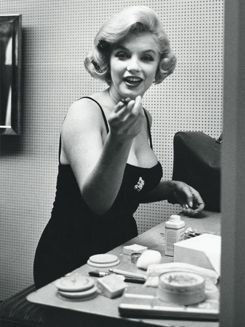The jar of Elizabeth Arden cream can be seen on the table in front of Marilyn.